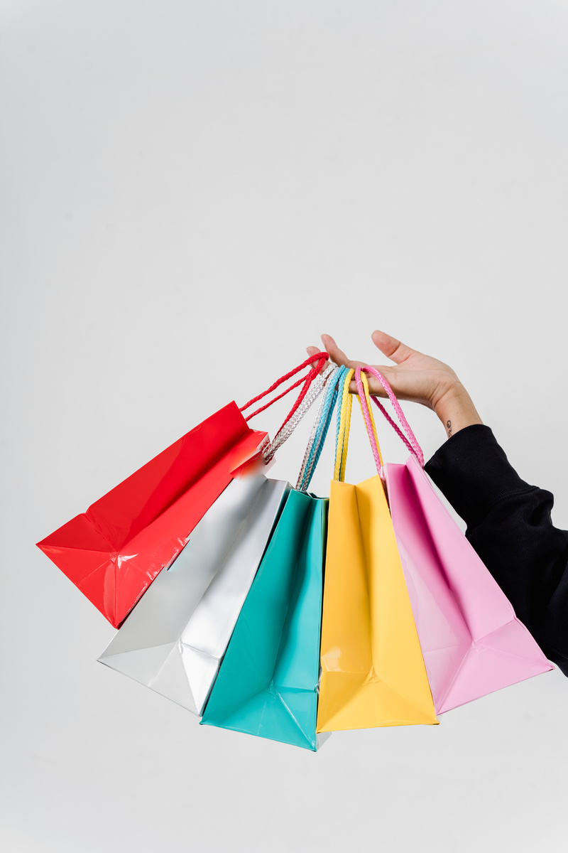 A Person Holding Variety of Shopping Bags