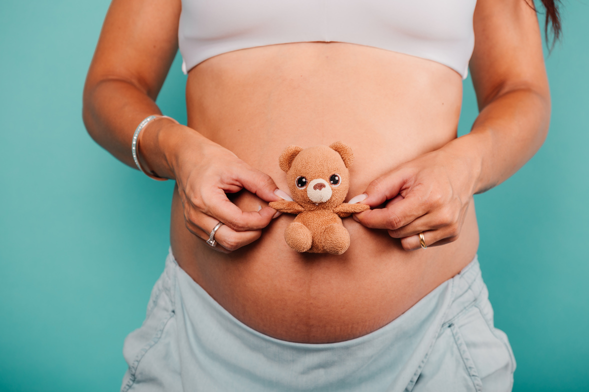 Pregnant Woman Expecting a Child Caresses Her Belly