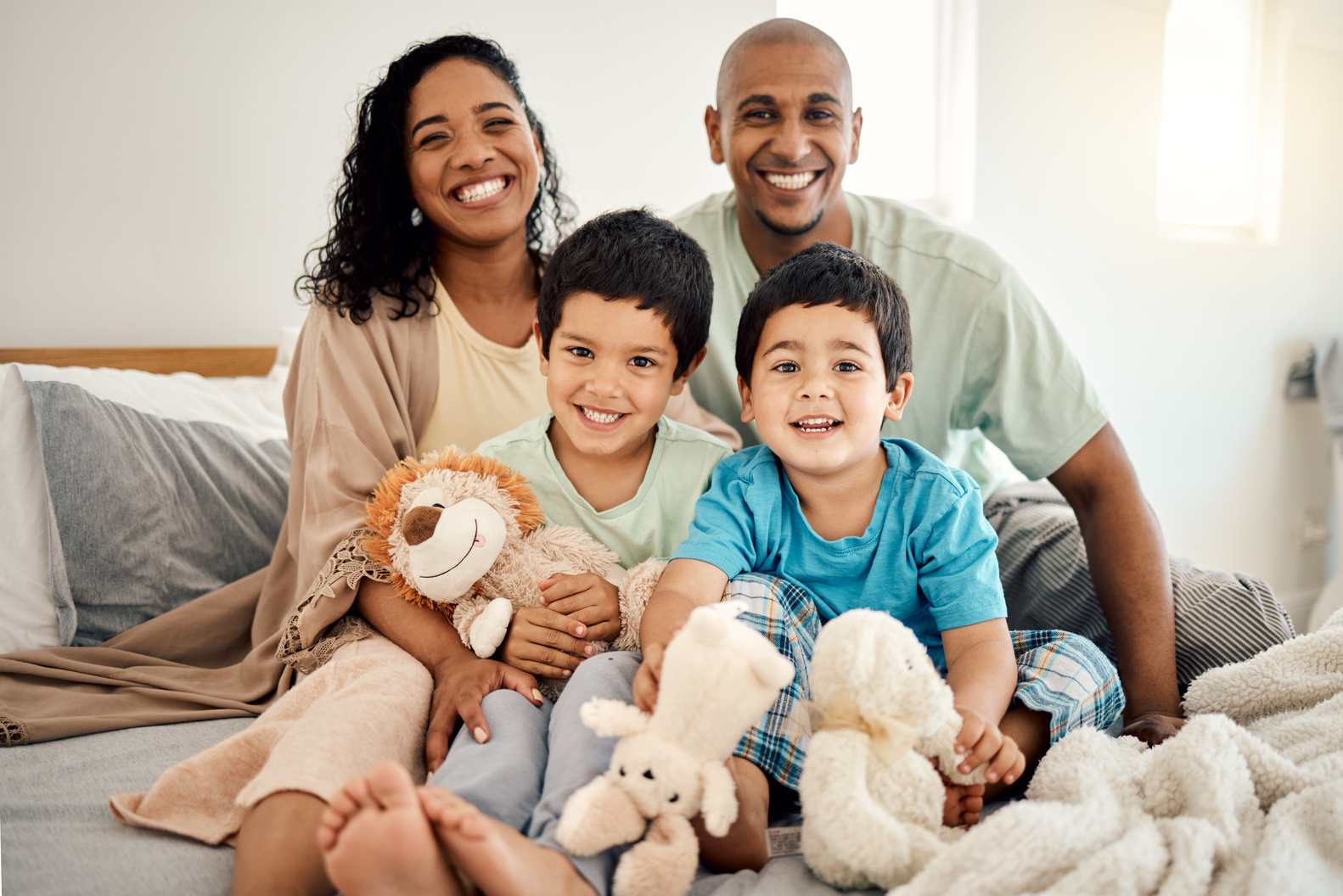 Happy , Bed and Portrait of Parents and Children Bonding in a Bedroom in a House and Playing Together. Care, Mother and Father Excited with Kids in the Morning as Love, Happiness and Care